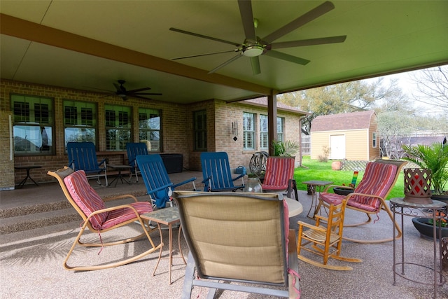 view of patio with a storage unit and ceiling fan