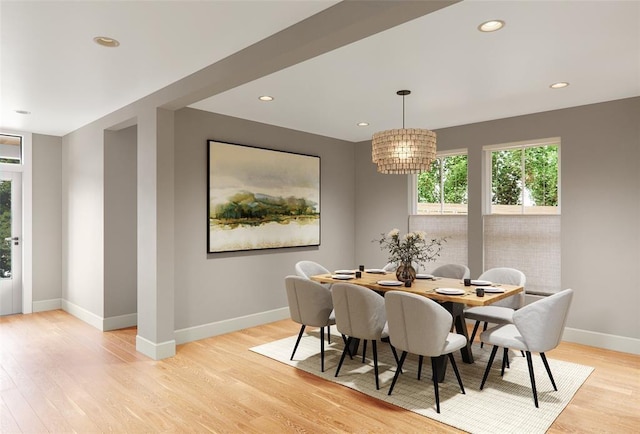 dining room with an inviting chandelier and light hardwood / wood-style flooring