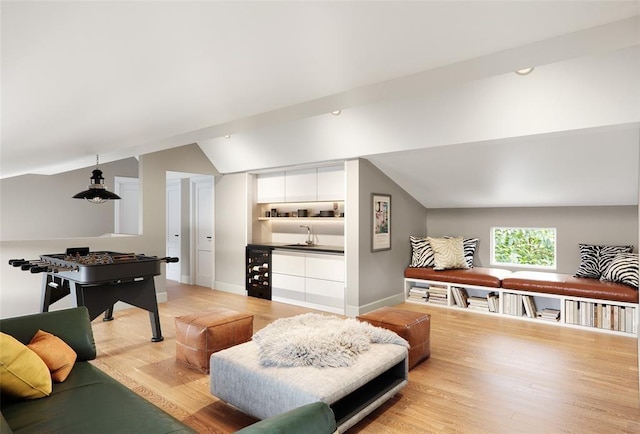 rec room featuring lofted ceiling and light hardwood / wood-style floors