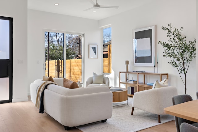 living room featuring ceiling fan and light wood-type flooring