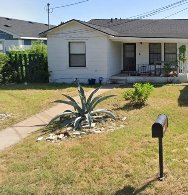 single story home with covered porch and a front lawn