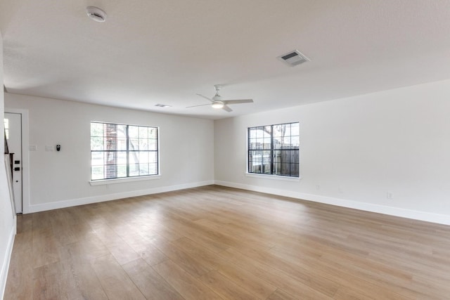 empty room with light wood-type flooring and ceiling fan