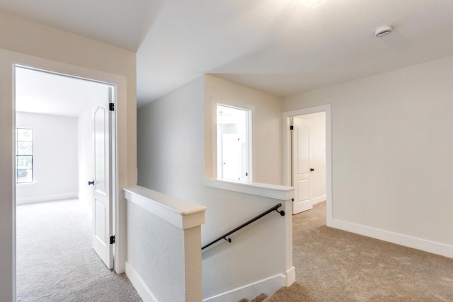 hallway with light colored carpet