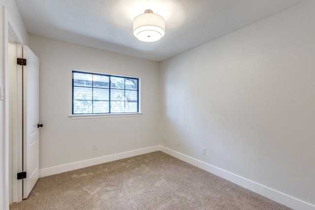 unfurnished room featuring light colored carpet