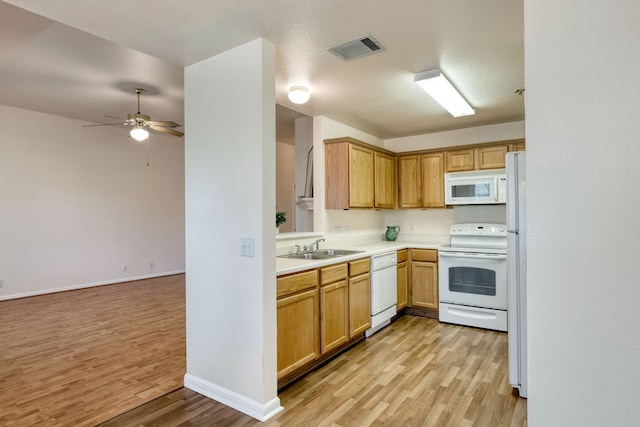 kitchen featuring white appliances, light wood-type flooring, ceiling fan, a textured ceiling, and sink