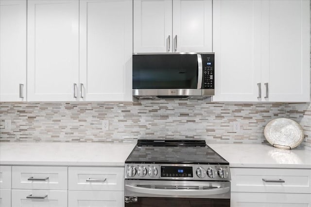 kitchen featuring white cabinetry, backsplash, and appliances with stainless steel finishes