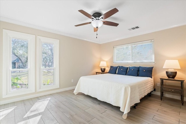 bedroom with ornamental molding, ceiling fan, light hardwood / wood-style flooring, and multiple windows