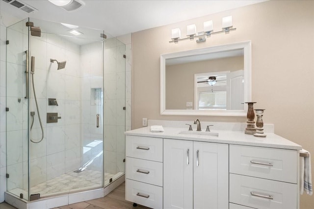 bathroom featuring ceiling fan, a shower with door, hardwood / wood-style floors, and vanity