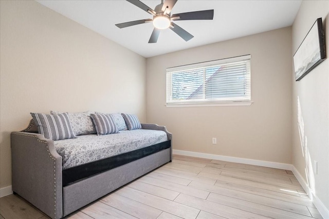 sitting room with ceiling fan and light wood-type flooring