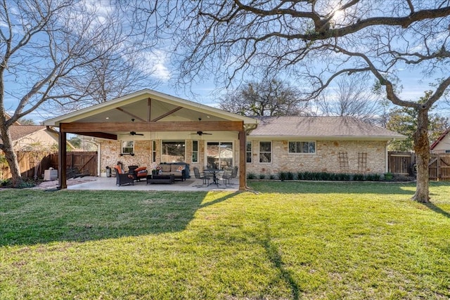 back of house with a lawn, ceiling fan, outdoor lounge area, and a patio