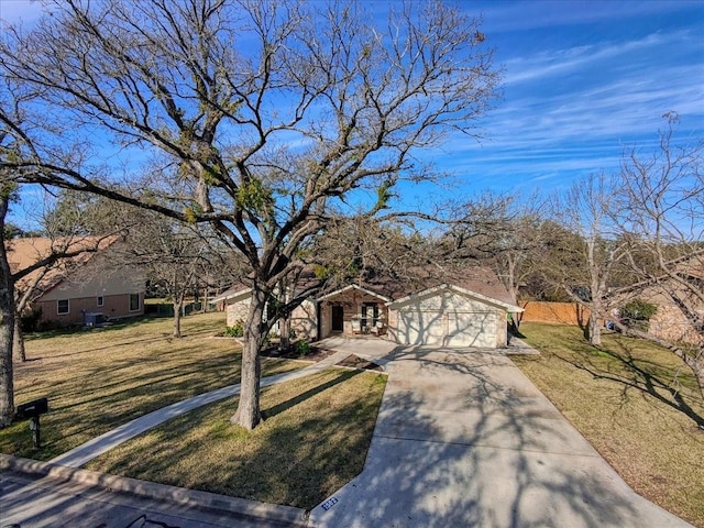 ranch-style home featuring a garage and a front yard