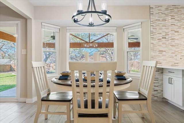 dining area featuring an inviting chandelier and light hardwood / wood-style floors