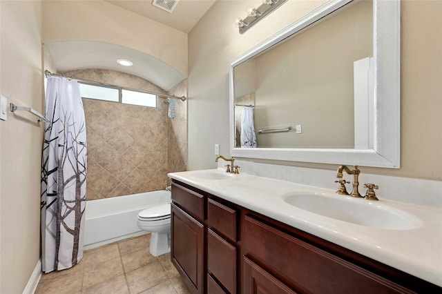 full bathroom featuring tile patterned floors, shower / tub combo with curtain, vanity, and toilet