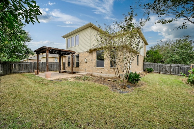 back of house featuring a patio and a lawn