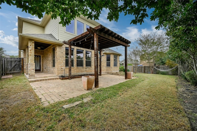 back of house featuring a lawn and a patio area