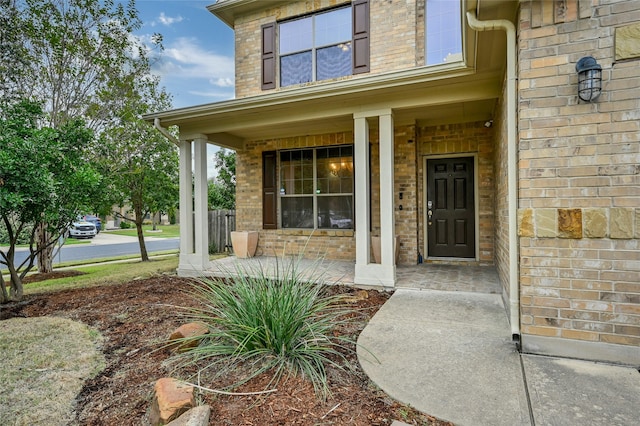 view of exterior entry featuring a porch