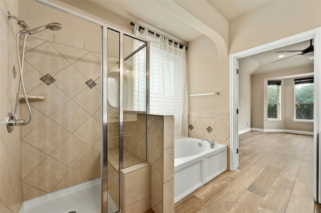 bathroom with ceiling fan and shower with separate bathtub