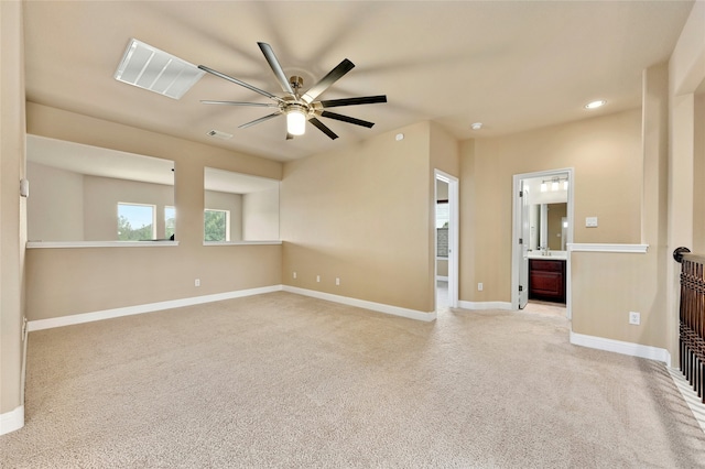 spare room with ceiling fan and light colored carpet