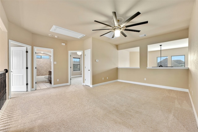 unfurnished living room featuring light colored carpet and ceiling fan