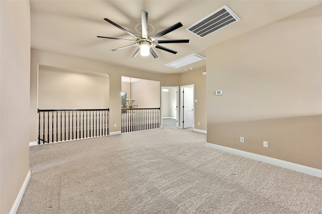 empty room featuring ceiling fan and carpet