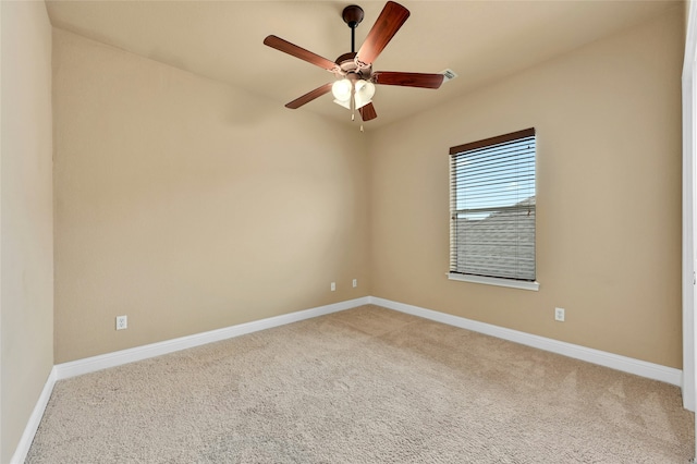 carpeted spare room with ceiling fan