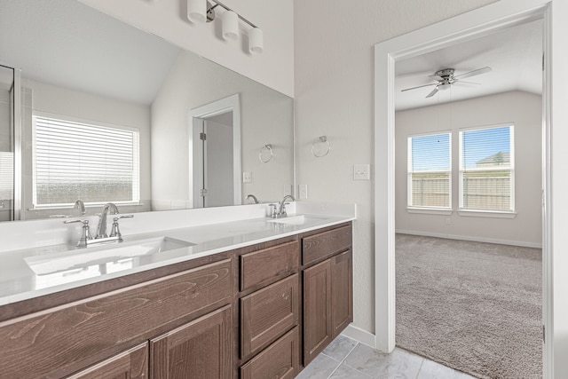 bathroom with ceiling fan, vaulted ceiling, and vanity