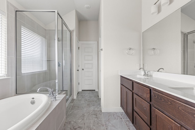 bathroom with vanity and shower with separate bathtub