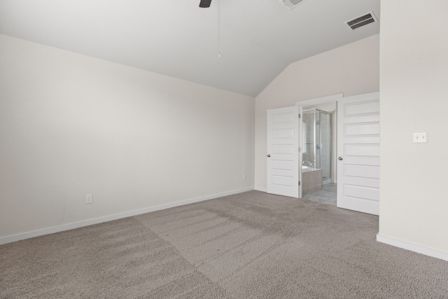 unfurnished bedroom featuring ceiling fan, ensuite bathroom, carpet floors, and lofted ceiling