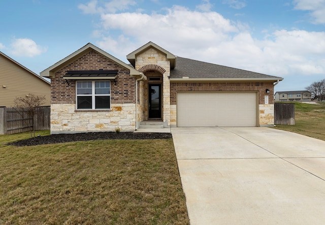 view of front of house with a front yard and a garage