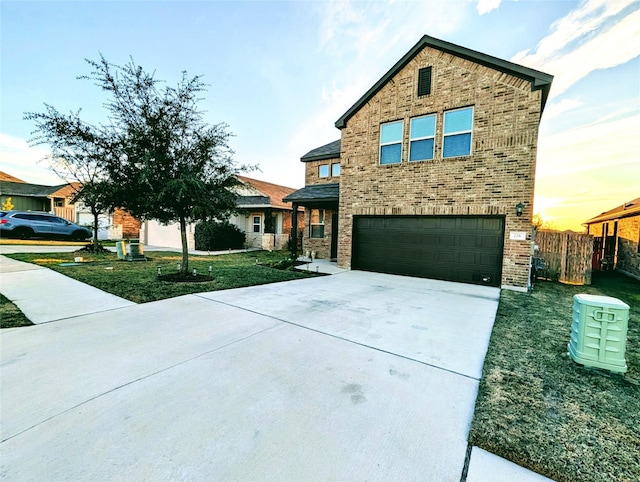 view of front of home featuring a garage and a lawn