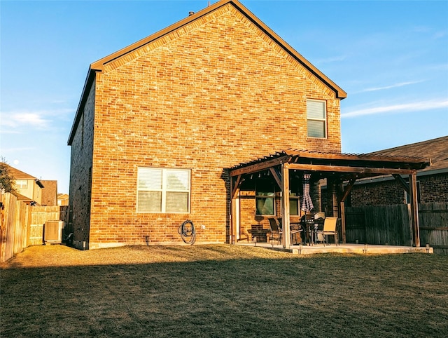 rear view of property featuring a pergola, a yard, cooling unit, and a patio area