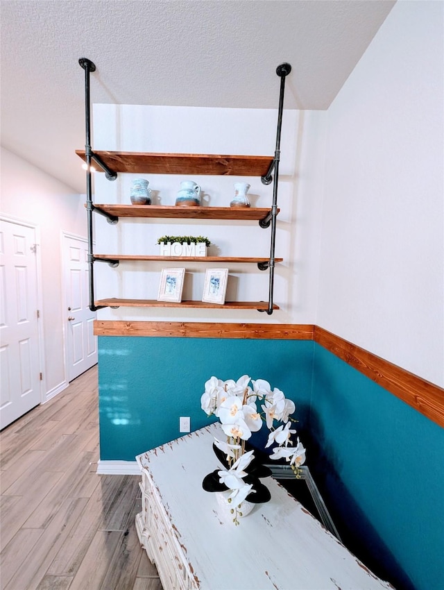 staircase featuring wood-type flooring and a textured ceiling