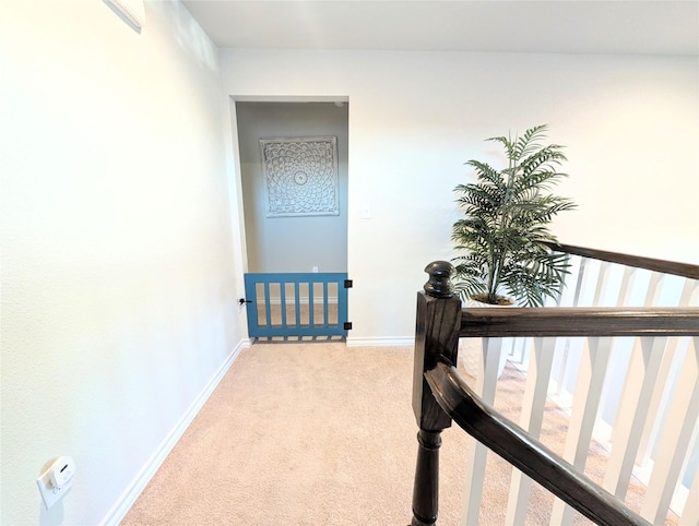 hallway with light colored carpet