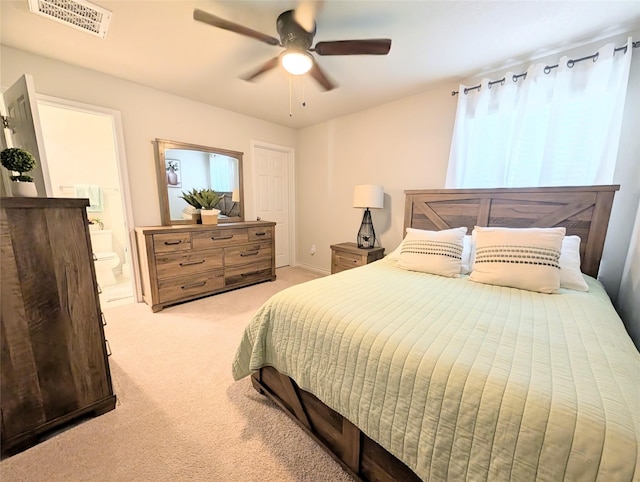 carpeted bedroom featuring ensuite bathroom and ceiling fan