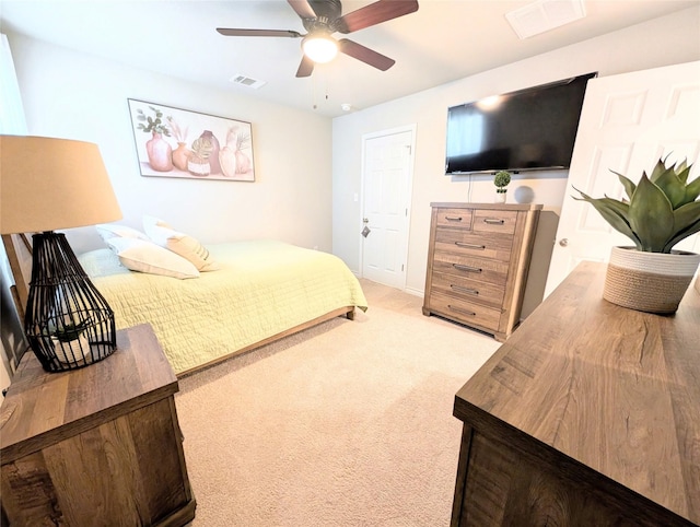 bedroom featuring light colored carpet and ceiling fan