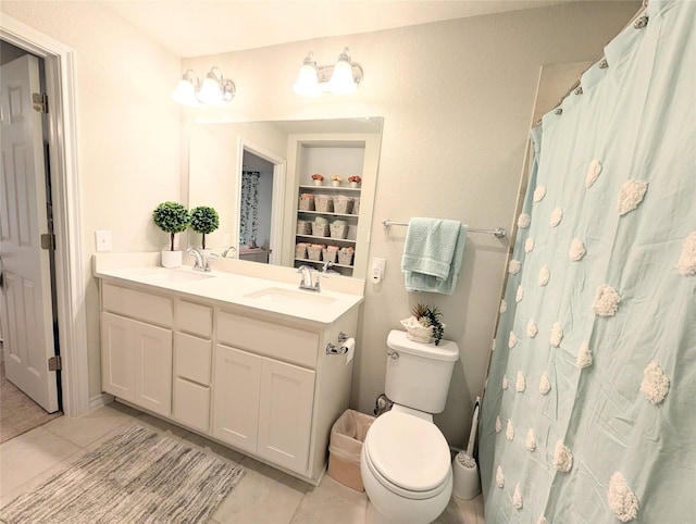 bathroom featuring toilet, tile patterned flooring, and vanity