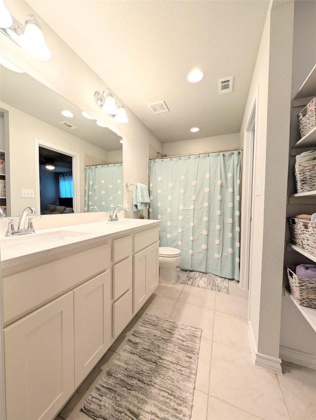 bathroom with vanity, tile patterned floors, and toilet