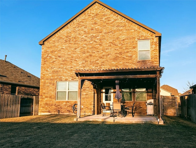 rear view of house with a yard and a patio area