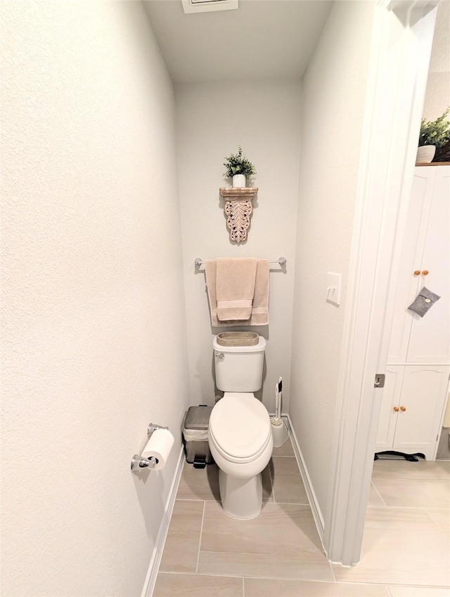 bathroom with tile patterned floors and toilet