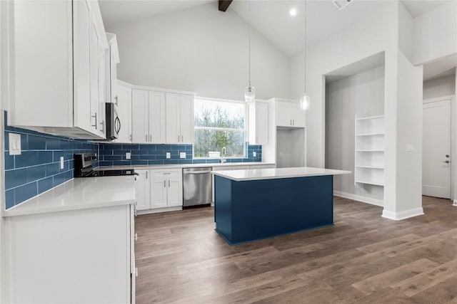 kitchen featuring decorative light fixtures, appliances with stainless steel finishes, dark hardwood / wood-style floors, a kitchen island, and white cabinets