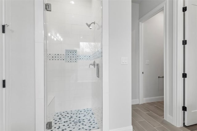 bathroom featuring a shower with shower door