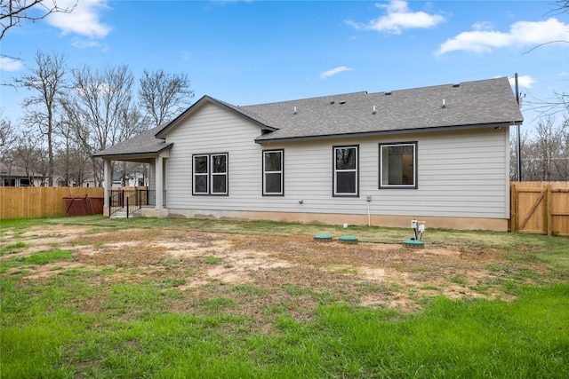 rear view of house featuring a yard