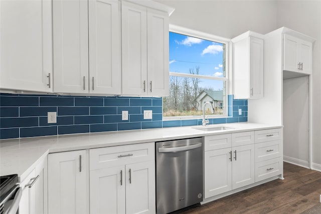 kitchen with stainless steel appliances, white cabinets, tasteful backsplash, and sink