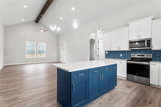 kitchen featuring appliances with stainless steel finishes, pendant lighting, beam ceiling, white cabinetry, and blue cabinets