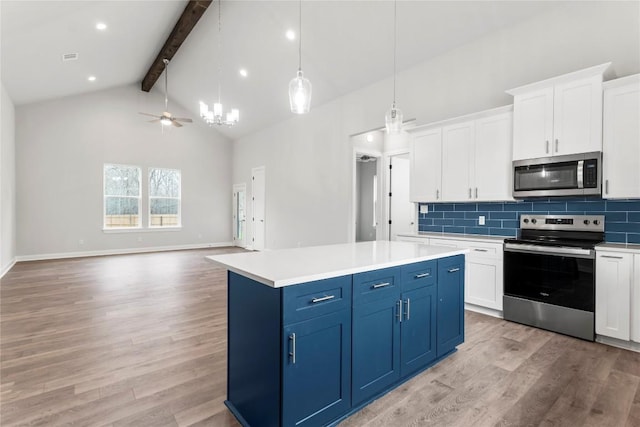 kitchen featuring decorative light fixtures, white cabinetry, a center island, stainless steel appliances, and blue cabinetry