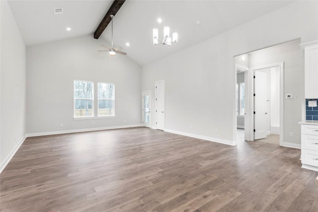 unfurnished living room featuring beam ceiling, ceiling fan with notable chandelier, high vaulted ceiling, and hardwood / wood-style flooring