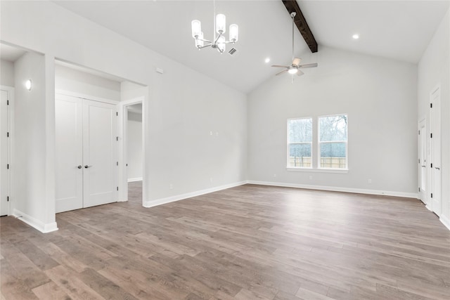 interior space with ceiling fan with notable chandelier, high vaulted ceiling, beamed ceiling, and hardwood / wood-style floors