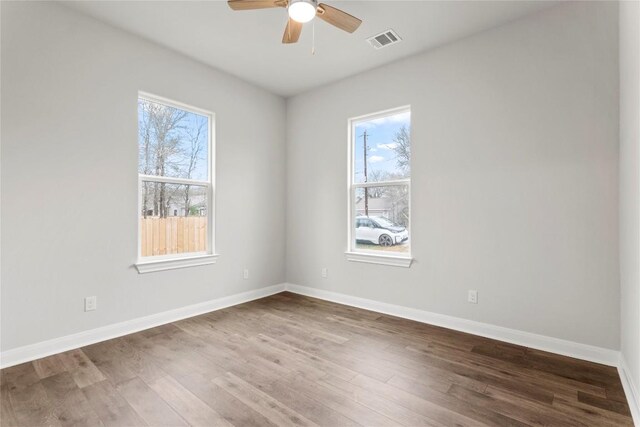 unfurnished room with hardwood / wood-style floors and ceiling fan