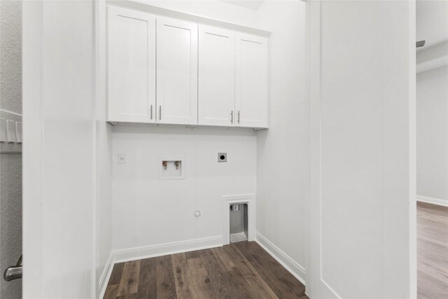 washroom featuring electric dryer hookup, hookup for a washing machine, cabinets, gas dryer hookup, and dark hardwood / wood-style flooring