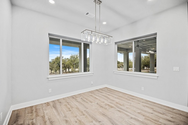 unfurnished dining area featuring ceiling fan and light hardwood / wood-style flooring